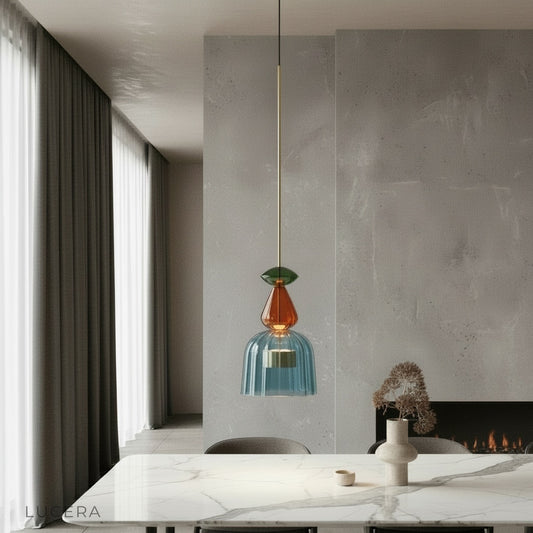 Ira stained glass pendant light glowing above a modern dining table in a bright living room