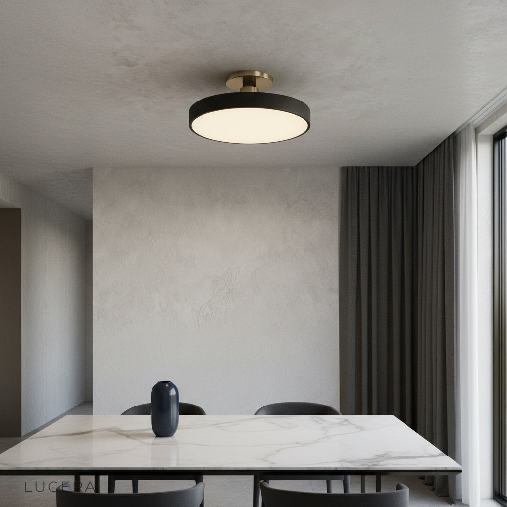 Alizarin ceiling light glowing softly above a modern living room seating area