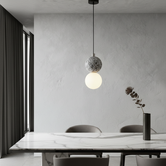 Xanadu pendant light glowing in modern living room with opal glass and terrazzo spheres