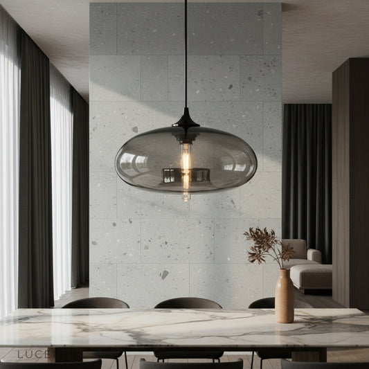 Oswin Pendant Light glowing over a modern dining table in a cozy living space