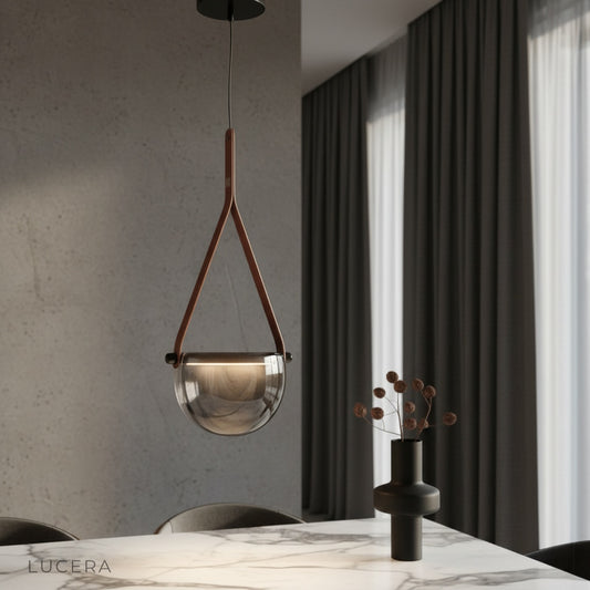 Glimmer leather pendant light glowing over a cozy bedroom nightstand