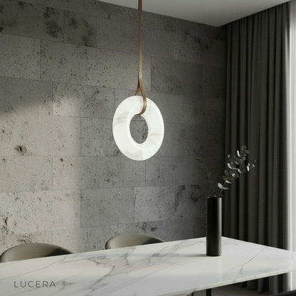Helix alabaster pendant light glowing above dining table in modern living room