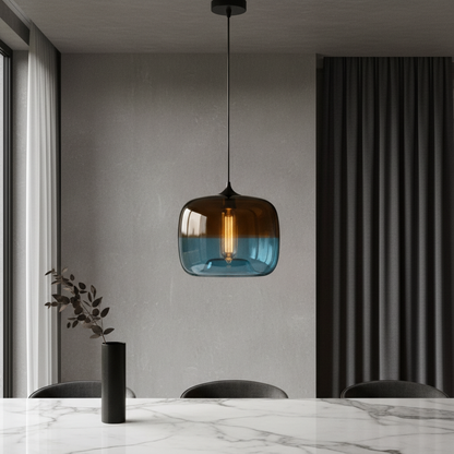 Minerva pendant light glowing over modern dining table in serene blue glass