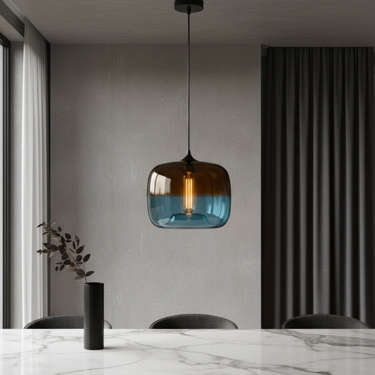 Minerva pendant light glowing over modern dining table in serene blue glass