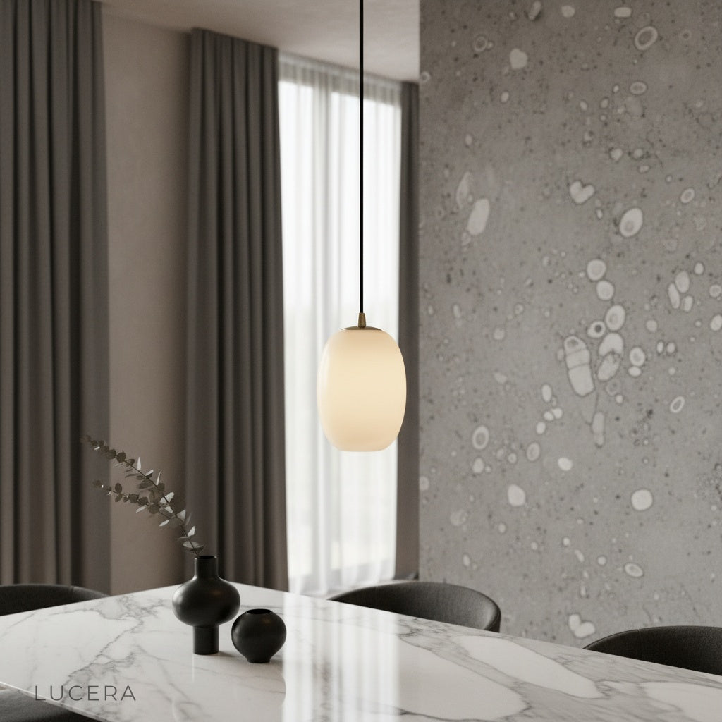 Embellish Alabaster pendant light glowing warmly above a cozy modern living room seating area