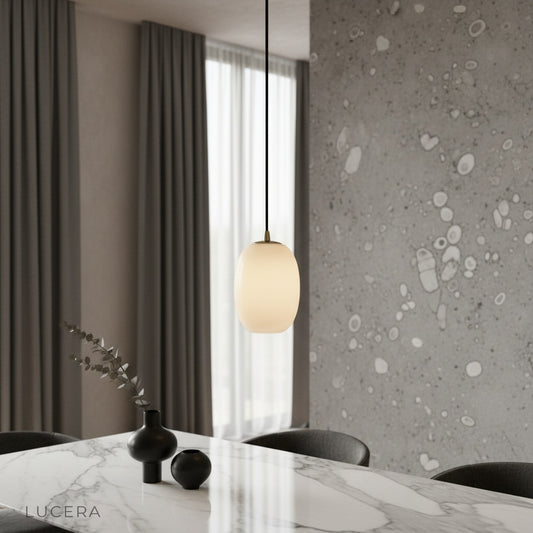 Embellish Alabaster pendant light glowing warmly above a cozy modern living room seating area