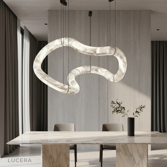 Fenwick alabaster chandelier glowing above a modern dining table in a bright living room