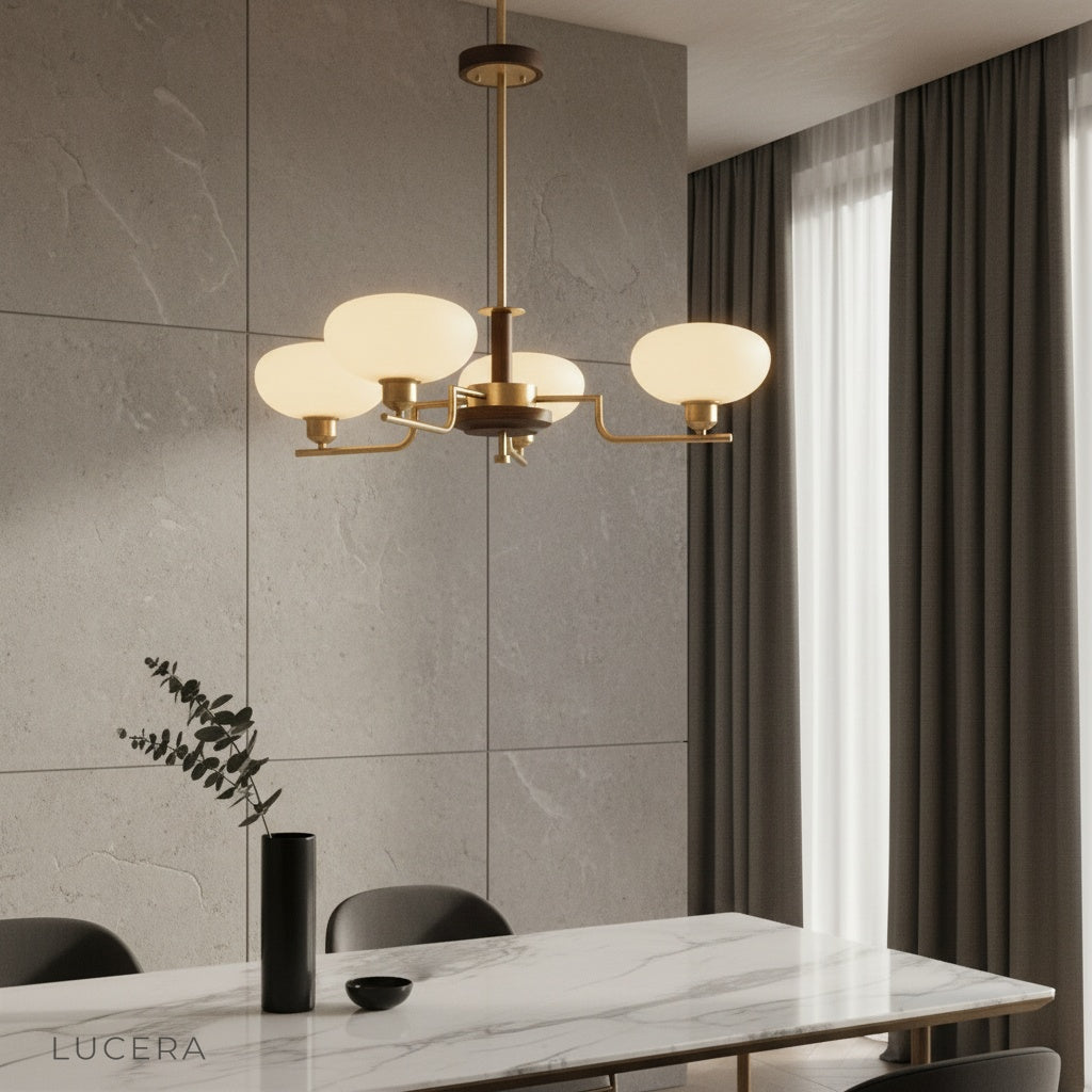 Eronix brass inlet chandelier illuminating a modern dining room with wooden table and glass shades