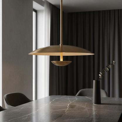 Ravish sculptural wide disc brass pendant light above dining table in modern interior