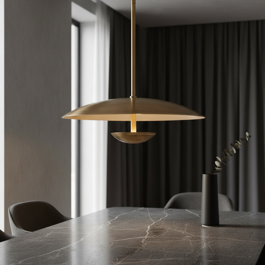 Ravish sculptural wide disc brass pendant light above dining table in modern interior