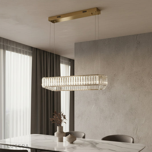 Benedetta chandelier with crystal accents glowing above a modern living room sofa