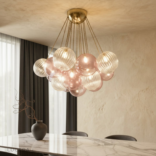 Brezza Indoor Chandelier glowing in modern living room with spherical glass shades