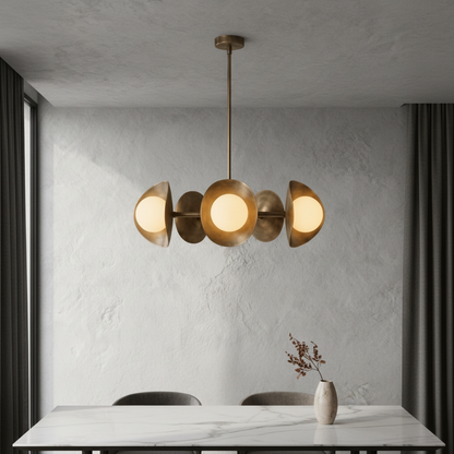 Lambrusco Chandelier brass and glass spheres illuminating a modern dining room