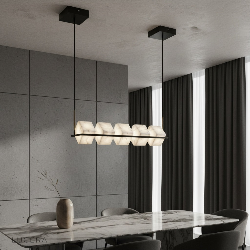 Locket Alabaster Chandelier glowing over modern dining table with black linear frame