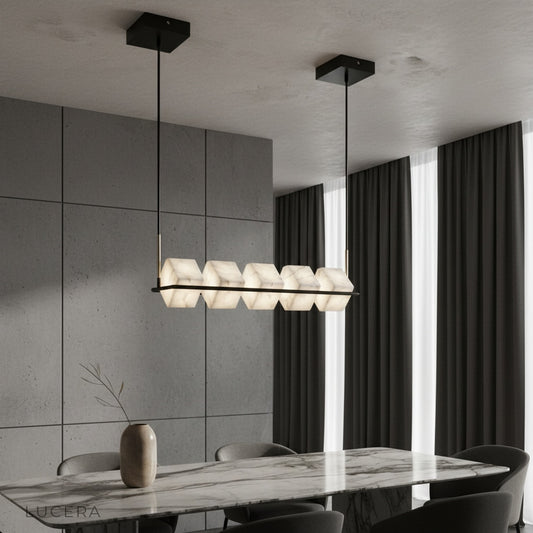 Locket Alabaster Chandelier glowing over modern dining table with black linear frame