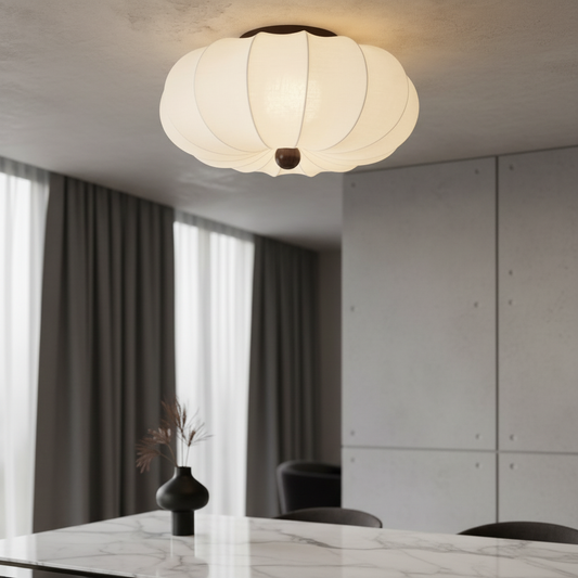 Teresa ceiling light glowing softly above a modern living room seating area