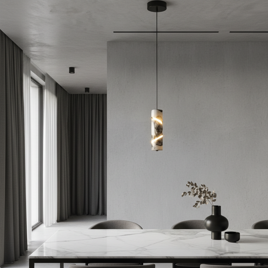Zest Marble Cylinder Pendant Light glowing above a modern bedside table in a cozy bedroom