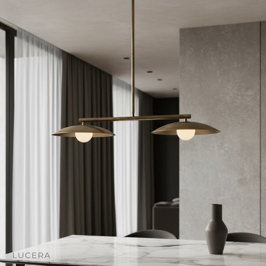Quivering Sculptural Disc Pendant Light glowing above a modern dining table in a bright living room