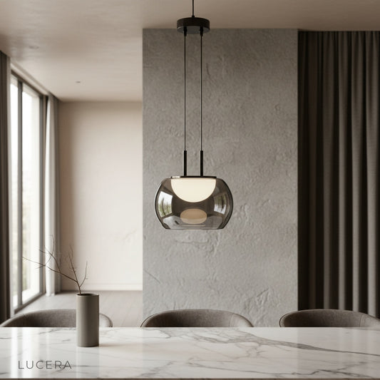 Gareth pendant light glowing over a modern dining table in a cozy contemporary interior