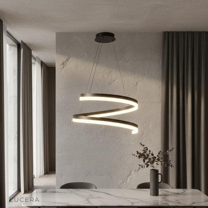 Hypnotize pendant light glowing above modern dining table in open-concept living room