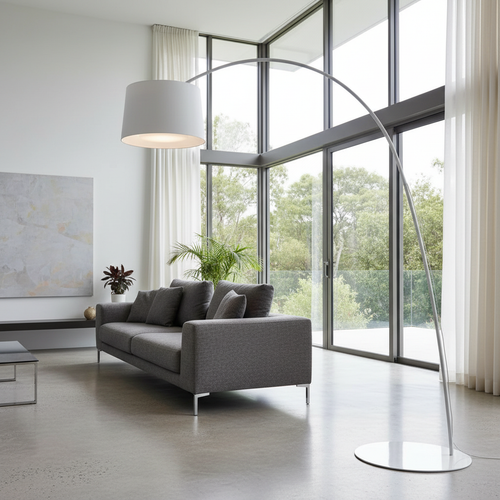 Gabbro arc floor lamp glowing beside a modern sofa in a minimalist living room