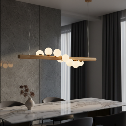 Svartr Nordic walnut wood LED chandelier hanging above a modern dining table with clear glass balls