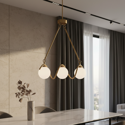 Verdandi gold copper glass chandelier illuminating modern dining room with warm ambient light