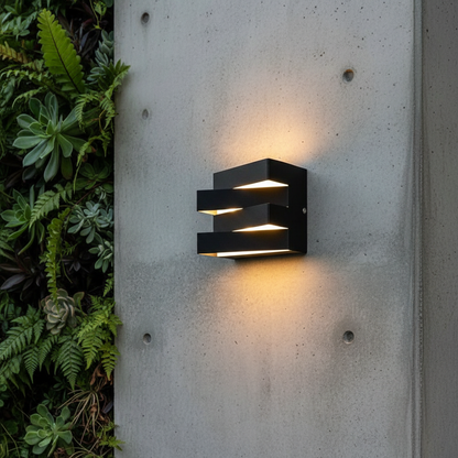 modern outdoor LED wall light illuminating a contemporary porch at dusk