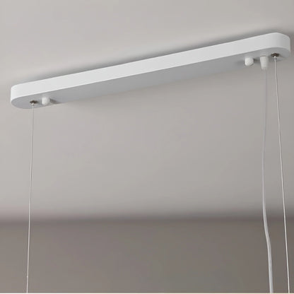 Close-up detail of fuchsia glass shade on Liora linear pendant highlighting translucent color and metal fittings