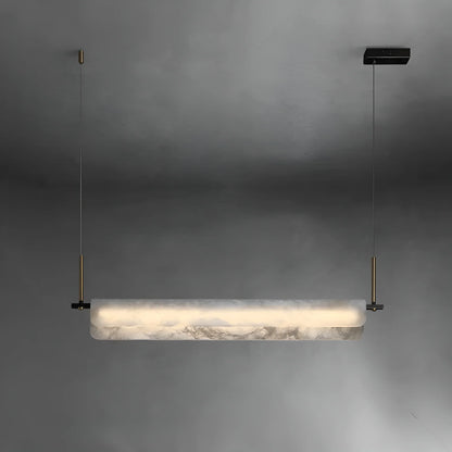Close-up detail of Spanish marble texture and brushed brass finish on the Viridian pendant light