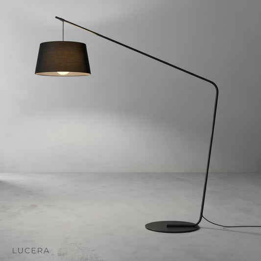 studio shot of Ignatian floor lamp with wide circular shade and sleek curved stem