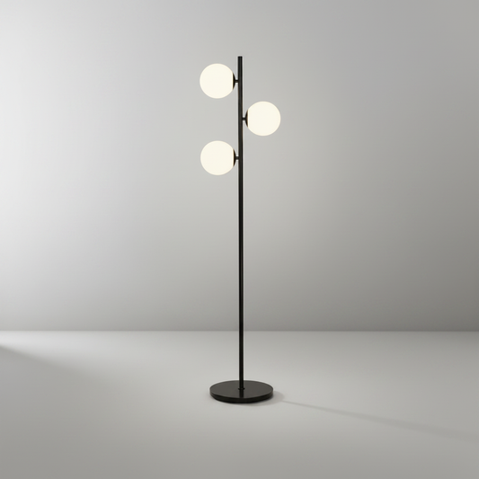 Black metal floor lamp with marble base and milky white glass shades on clean studio background