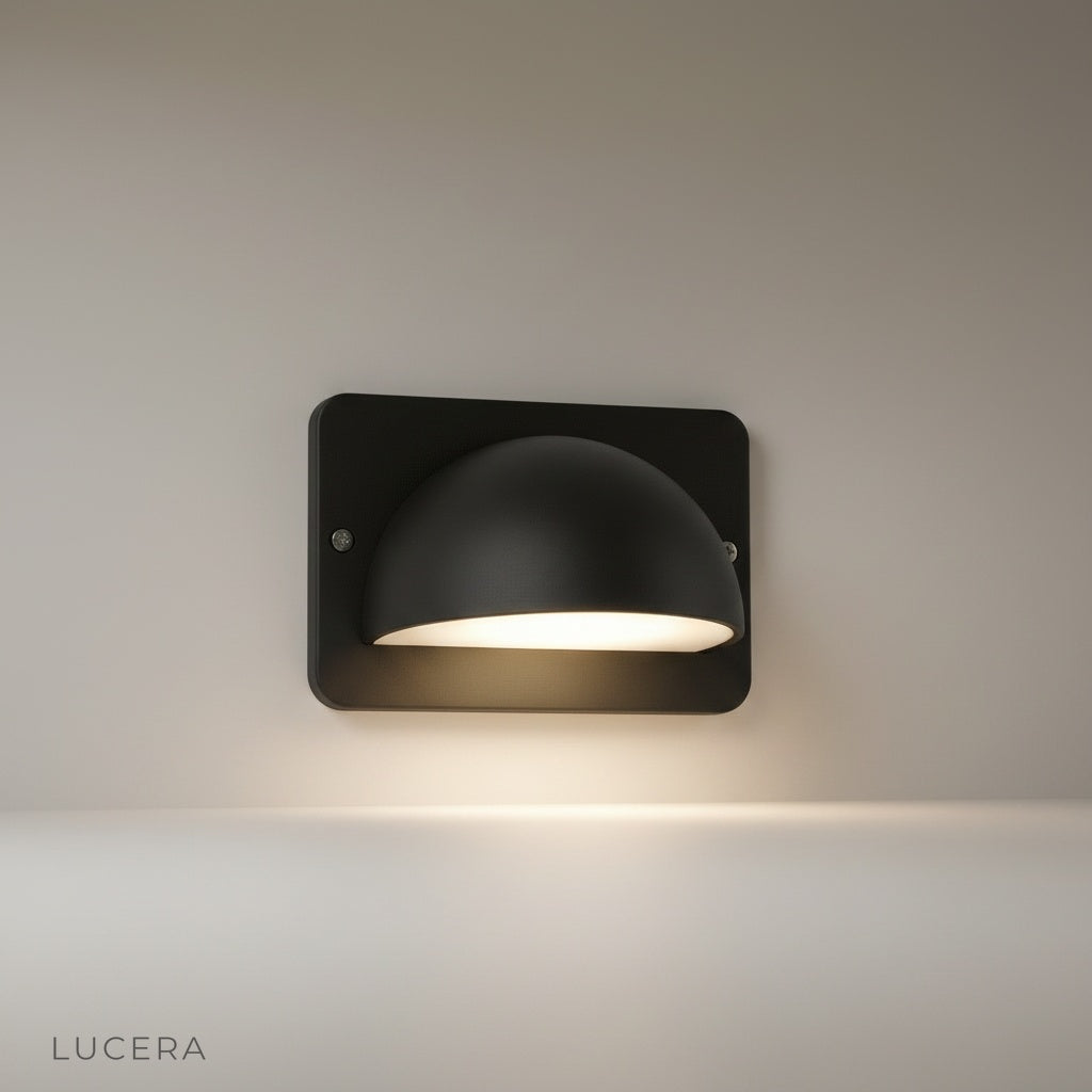 studio shot of Rosalie outdoor wall lamp with dome aluminum shade and PC diffuser