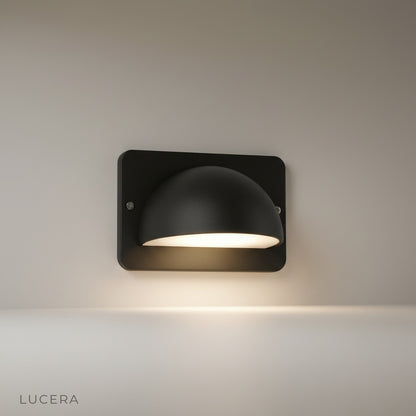 studio shot of Rosalie outdoor wall lamp with dome aluminum shade and PC diffuser