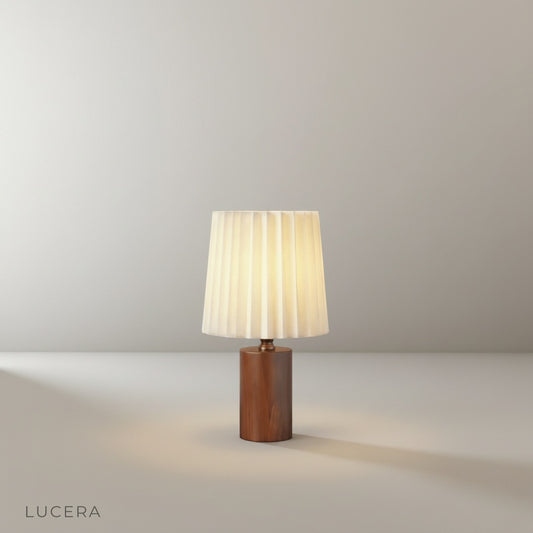 Studio shot of Pandora Table Lamp front view with solid wood frame, antiqued brass accents, and pleated cream linen shade