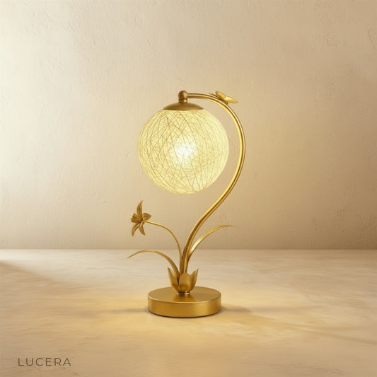 Domenica Table Lamp studio shot on neutral background, frosted glass orb and sleek brass stand