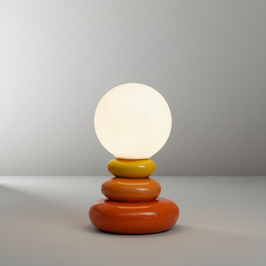 Studio shot of Lucera Yellow Ochre Table Lamp with stacked ceramic base and lunar lampshade