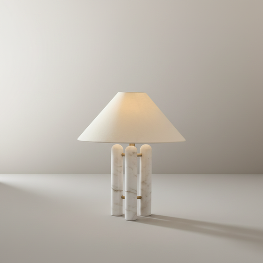 Studio shot of Oblate Table Lamp with white fabric shade and marble base on neutral background