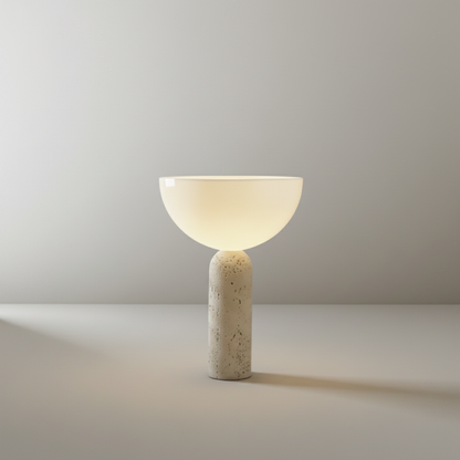Studio shot of Tristan Table Lamp front view showing travertine base and clear glass dome