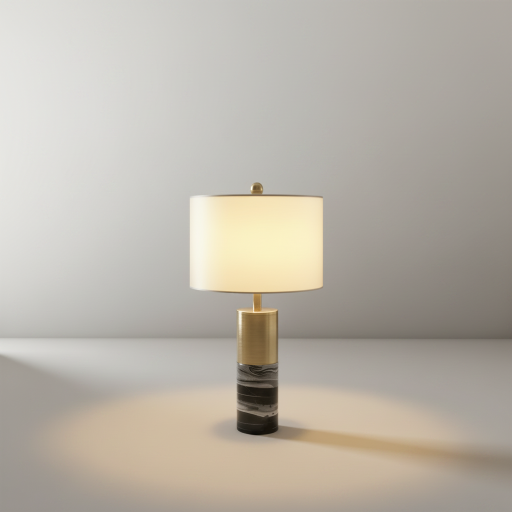 Studio shot of Essere Table Lamp with cylindrical marble base and metal accent on clean white background