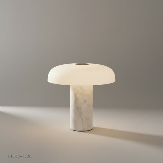 studio shot of Beatrice table lamp on a neutral background showing its cylindrical marble base and iron dome