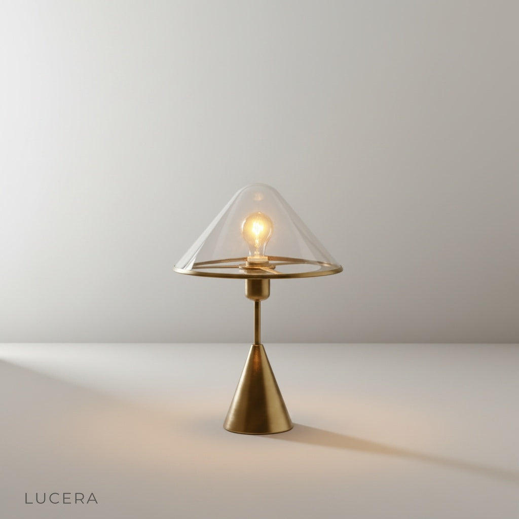 Studio shot of manganese blue conical base lamp with transparent glass shade