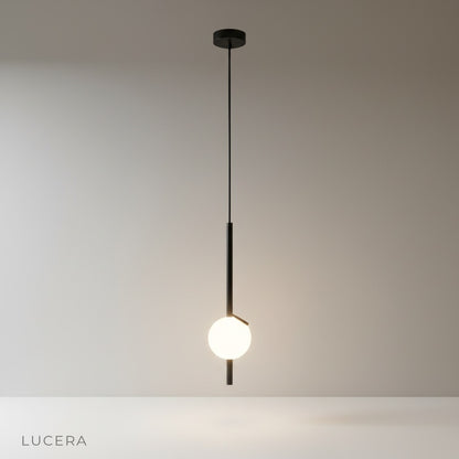 Minimalist glass ball pendant light on clean white studio background, front view