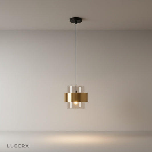 studio shot of Ivor pendant light with cylindrical amber glass shade and brass gold ring accent