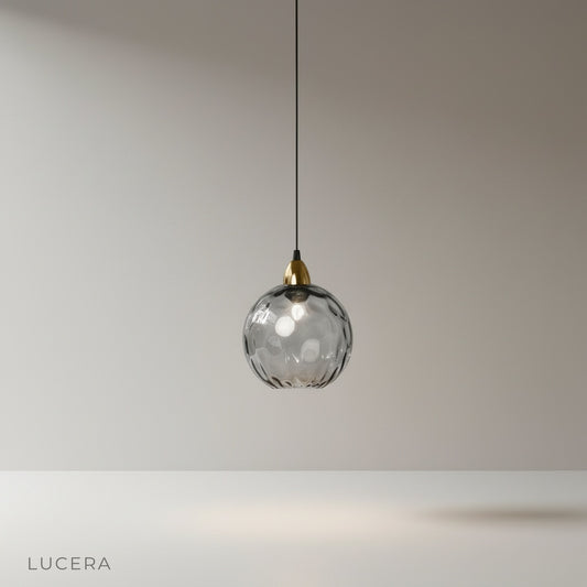 Kronos pendant light studio shot on clean white background, gold accents and glass shade
