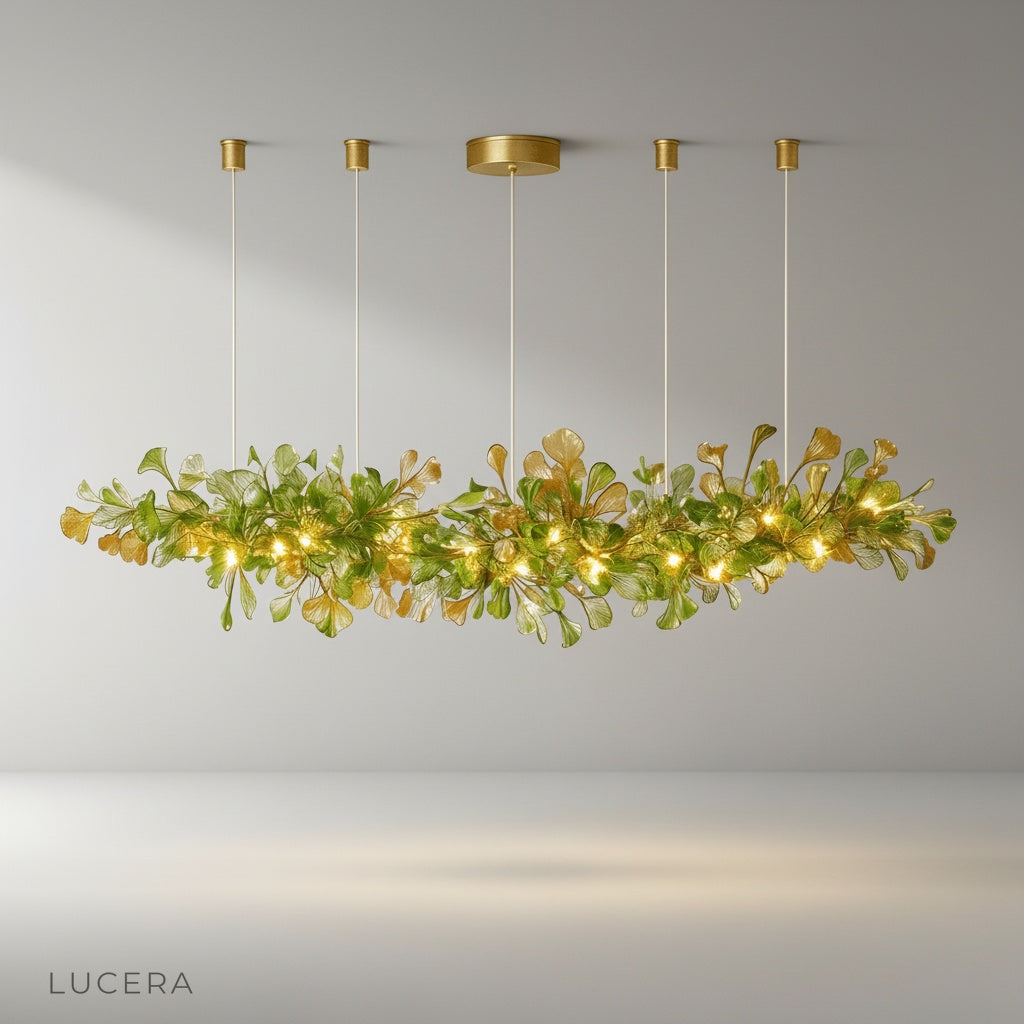 Paola chandelier with copper and glass ginkgo leaves glowing above modern dining table