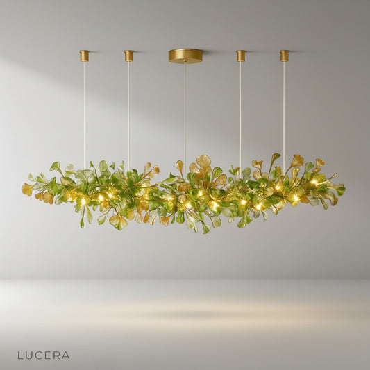 Paola chandelier with copper and glass ginkgo leaves glowing above modern dining table