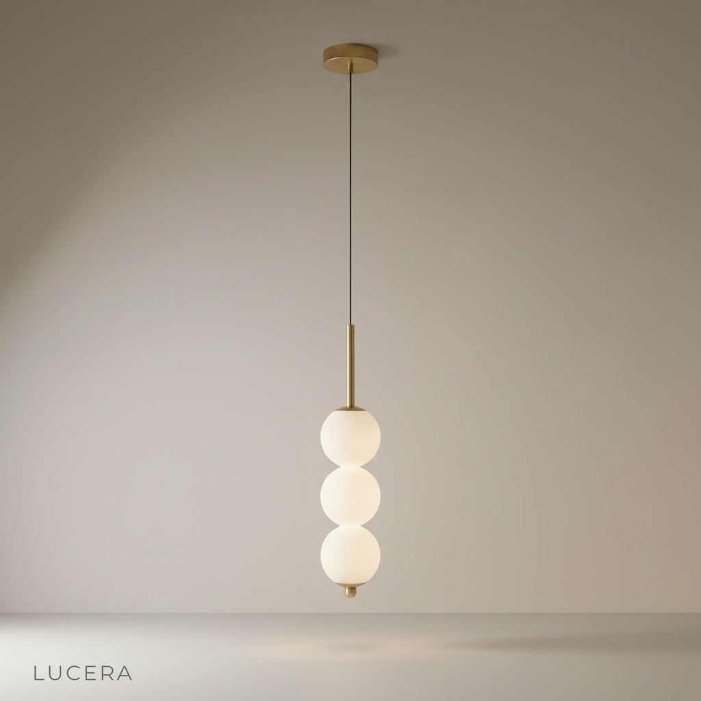 studio shot of Meridian Pendant Light with three glass ball shades on clean white background