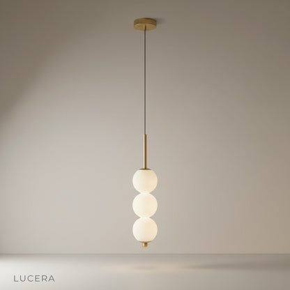 studio shot of Meridian Pendant Light with three glass ball shades on clean white background