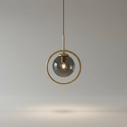 Caelus pendant light studio shot on clean white background showing gold metal ring and glass sphere